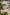 Outdoor showroom with various paving slabs, stone walls, seating area, and landscaped plants