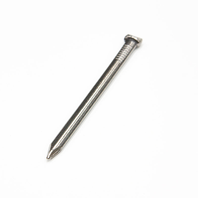 Single steel masonry nail on white background, construction fastener for building projects