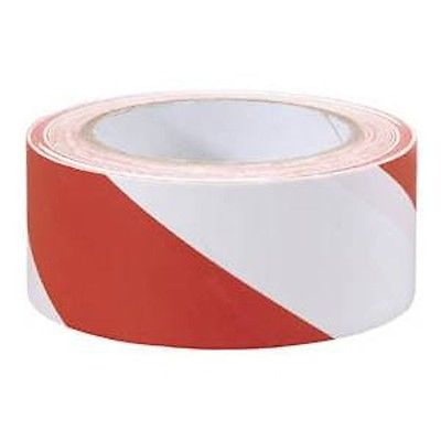 Red and white striped barrier tape roll for marking hazardous areas or construction sites