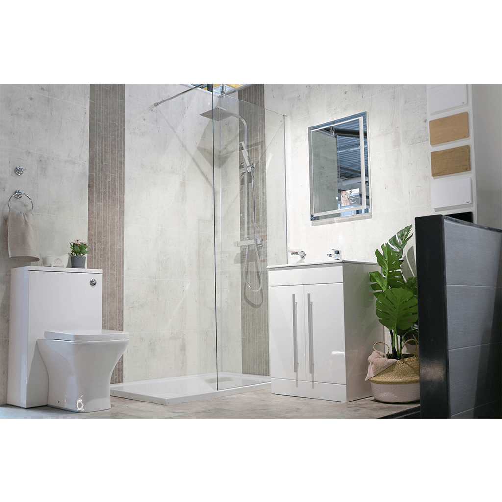 Modern bathroom with walk-in glass shower, wall-hung toilet, white vanity, and large mirror