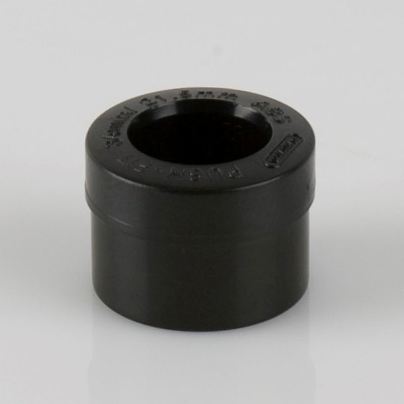 Black plastic pipe reducer fitting for plumbing or building material applications