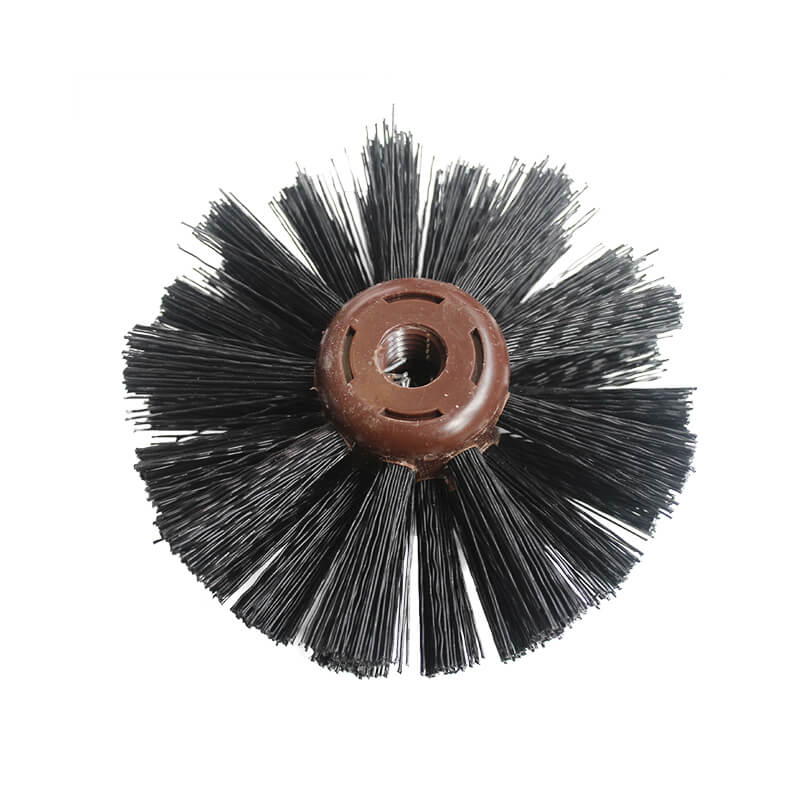 Round black wire brush head with brown plastic center for cleaning or power tools