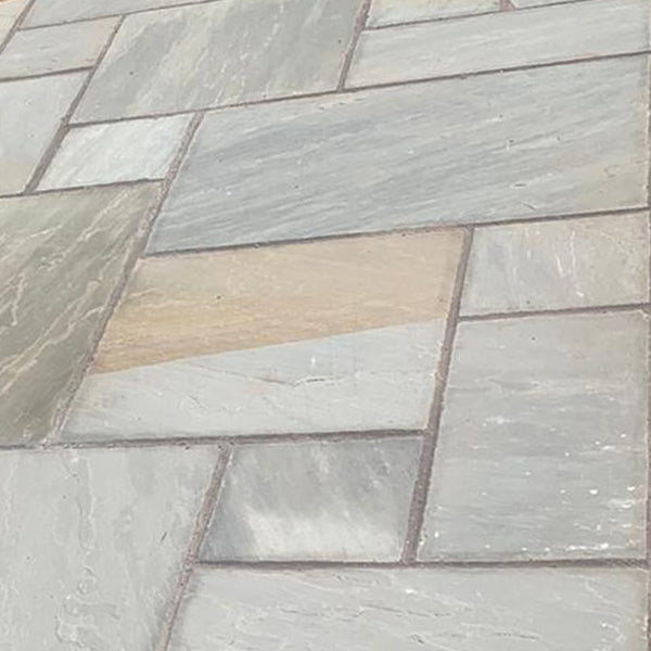 Grey sandstone paving slabs in a random pattern, ideal for patios or outdoor flooring
