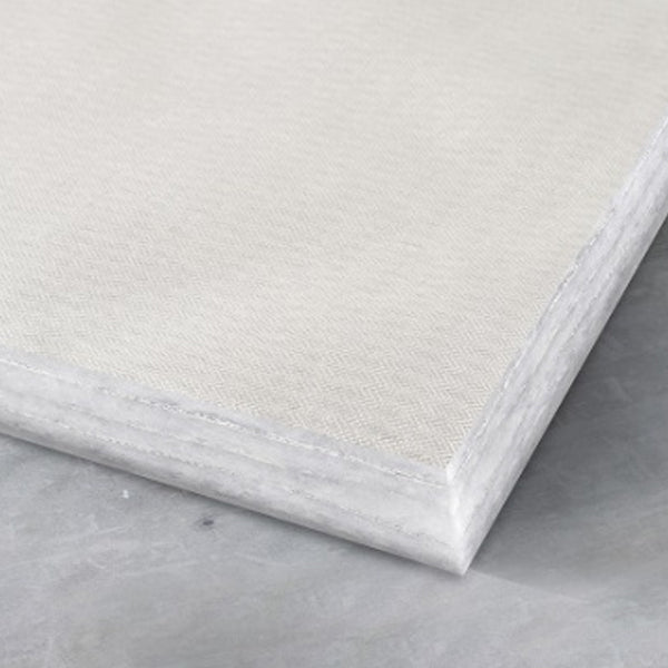 Close-up of a white plasterboard sheet on a concrete surface, building material