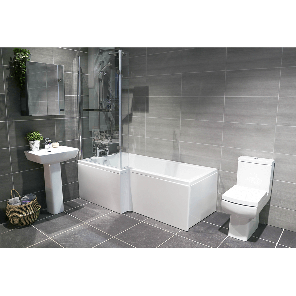 Modern bathroom with L-shaped shower bath, pedestal sink, and toilet on grey tiles