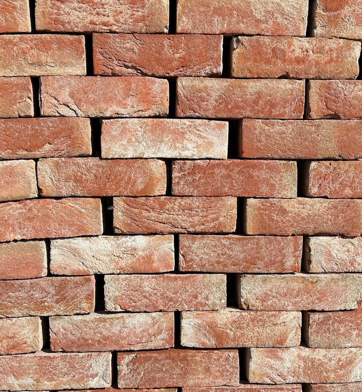 Stack of red clay bricks for building and construction supplies
