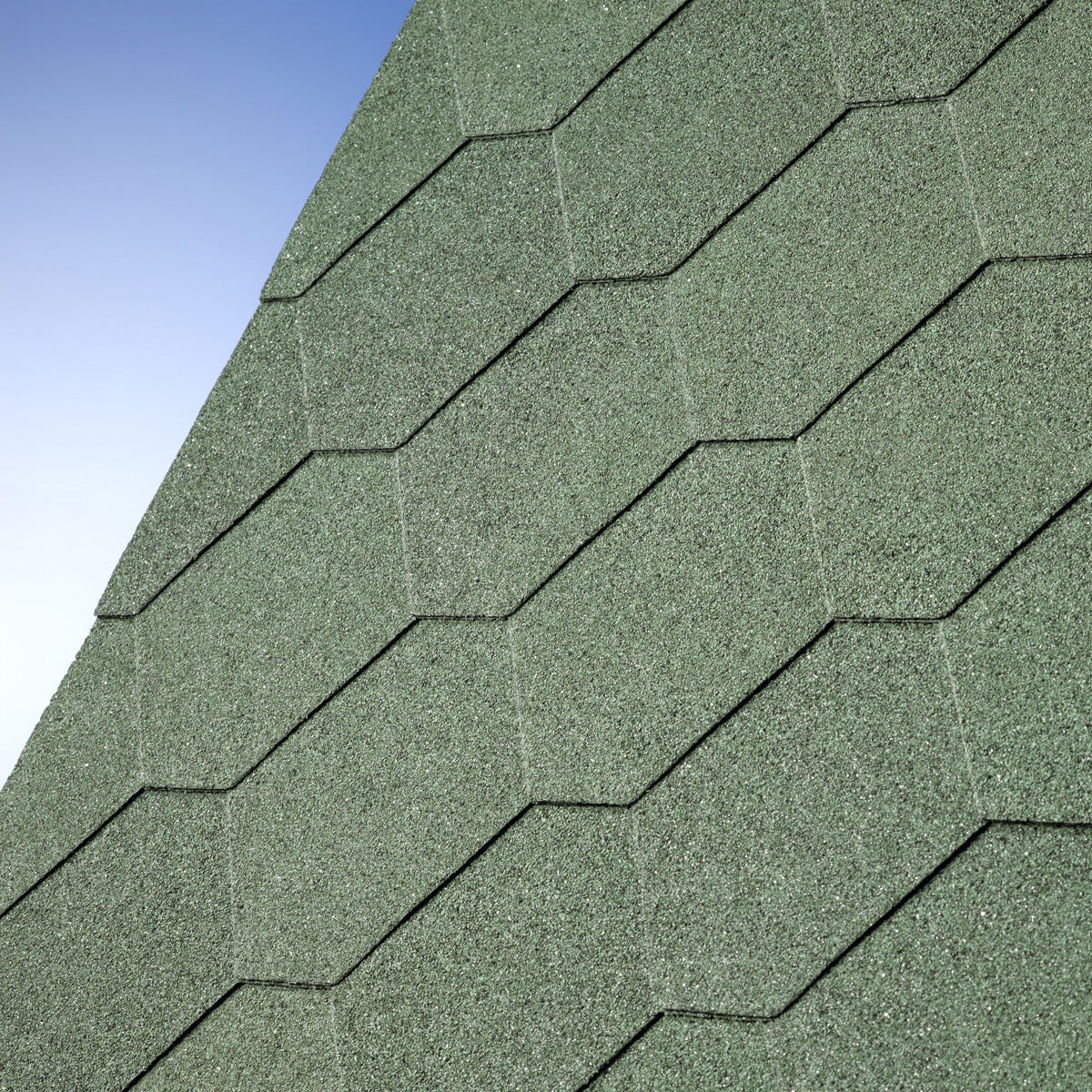 Green asphalt roofing shingles in hexagonal pattern under blue sky
