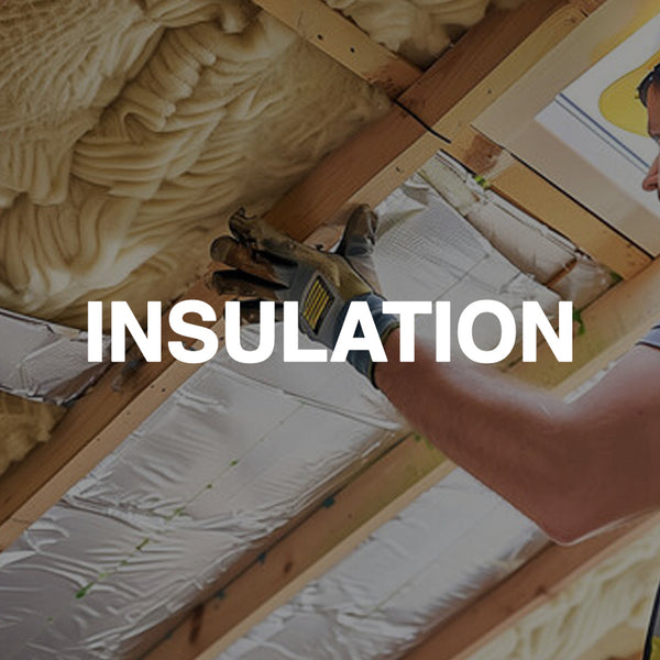 Worker installing loft insulation and foil insulation in a timber roof space